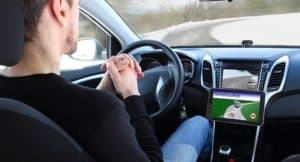 driver navigating self driving car