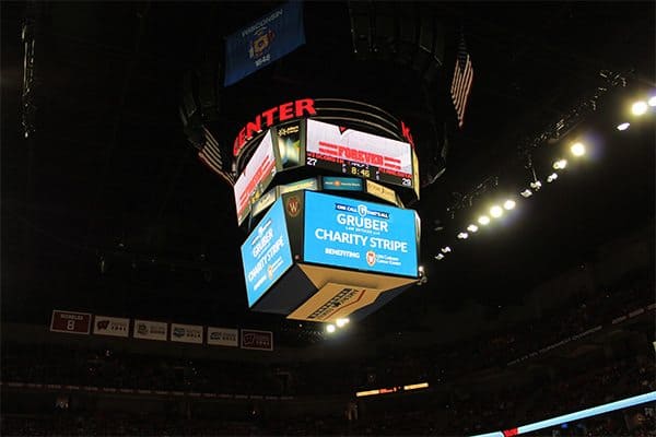 Gruber Law ad on the big monitor at Bucks Stadium