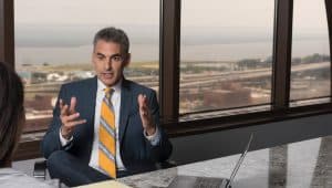 David Gruber in a conference room discussing a case with a client after a car accident