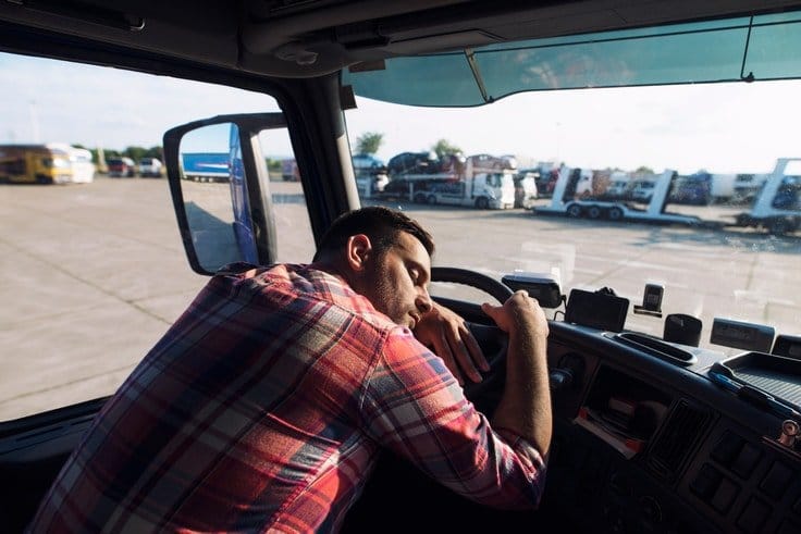 truck driver sleeping on the steering wheel