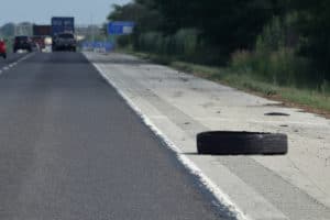 A piece of tire comes off a semi and lies on the shoulder of I55