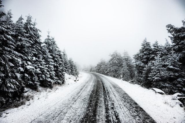 snowy mountain road curves int he distance