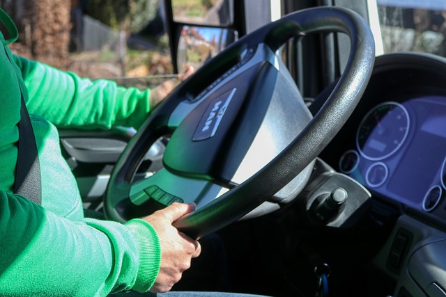 the interior of a truck cab with a driver holding the steering wheel