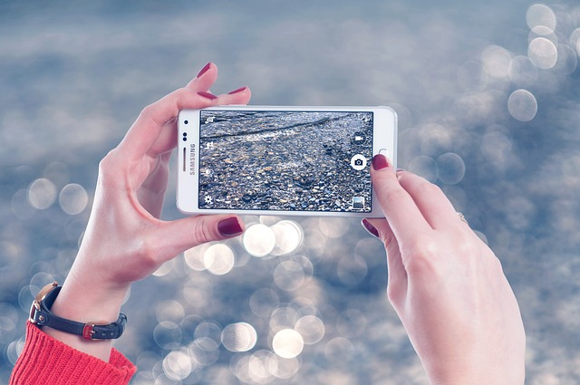 close up of a smart phone taking a picture of a road after an accident