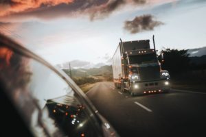 truck passing a car on a country road