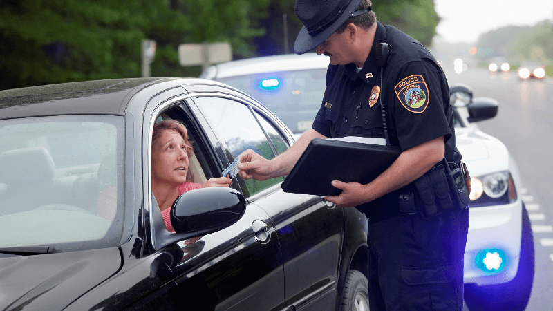 Police giving woman a ticket for not wearing a seatbelt