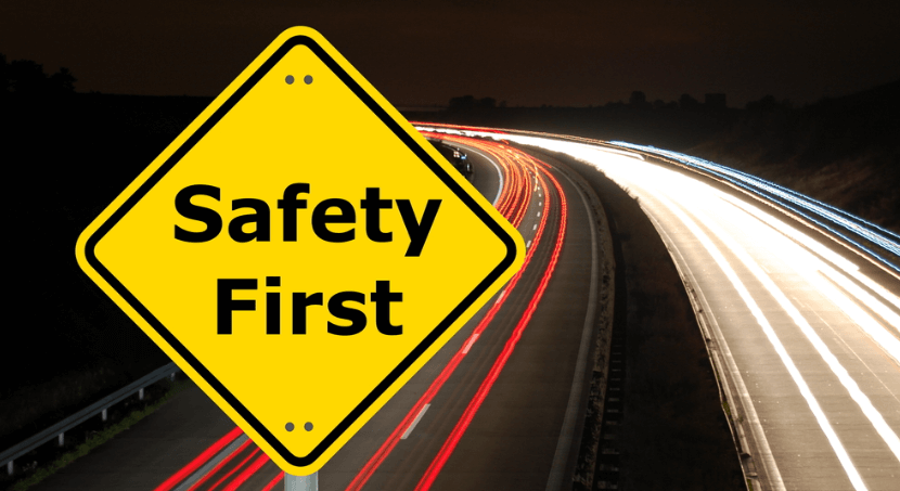 safety driving safely sign with highway in the background