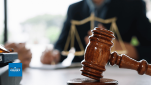 Gavel on desk with the scales of justice in the background