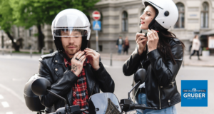 man and woman putting on helmets on motorcycle