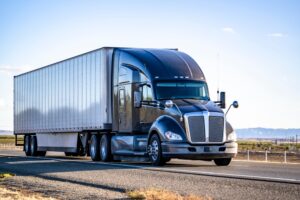 A commercial truck drives on a road at risk of causing a crash. Our Madison, WI, truck accident lawyers can help you after a crash.