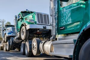 One teal semi hauls two other semis, leading one to wonder: What evidence is needed in a truck accident case?