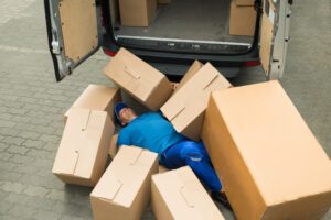 A person covered in packages after a crash wonders: What is the average Amazon truck accident settlement?